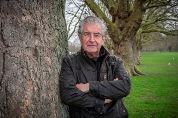 Tony Juniper leaning against a tree