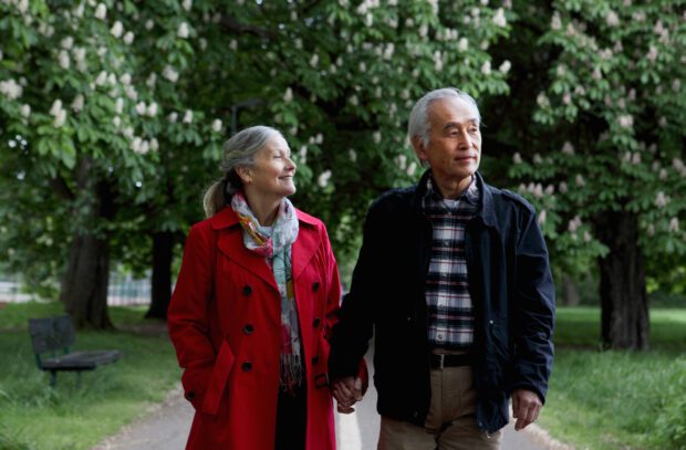 Older couple walking in park