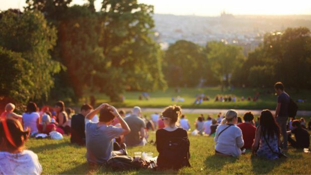 Many people sat within an urban park