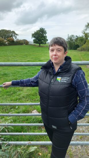 Ceri Meehan standing in front of a farm gate 