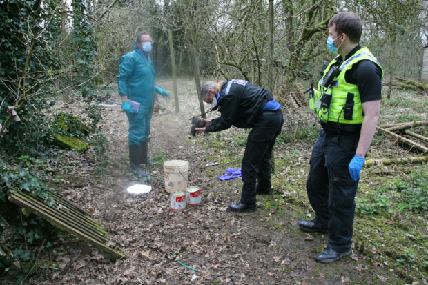 Dorset Police & Natural England with two containers of Cymag
