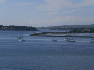 A view of Brownsea lagoon and harbour entrance with boats on the water, Poole Harbour (Image by Douglas Kite)