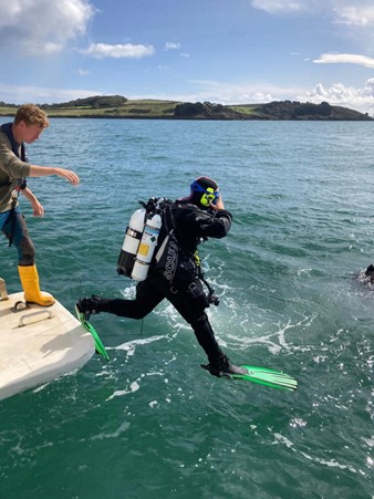Angela Gall (Natural England) entering the water for a maerl dive survey. Credit Lucy May