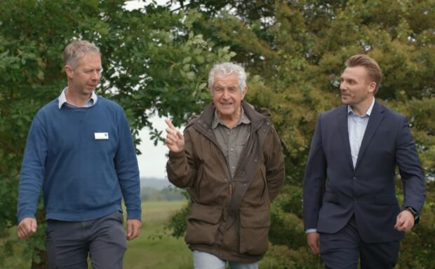 James Seymour, left, walking with chair of Natural England Tony Juniper, and Redrow technical director Dan Hoare