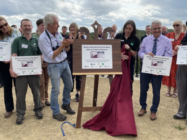 Tony Juniper unveiling the plaque celebrating the declaration of Risley, Holcroft and Chat Moss National Nature Reserve, July 2025