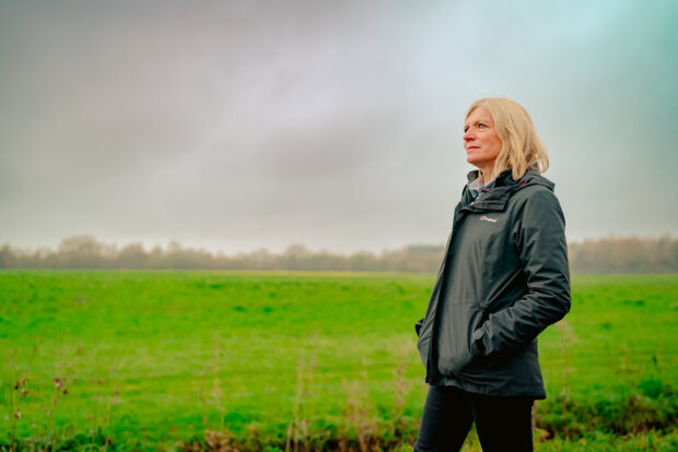 Marian Spain with a field behind her.